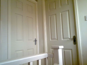 White panelled internal door fitted at top of staircase
