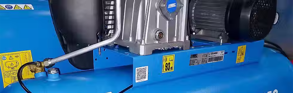 Industrial air compressor motor and belt housing close up
