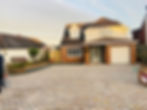 A house with a cobbled driveway and a garage