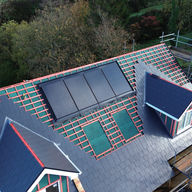 Roof renovation in progress with solar panels fitted on pitched roof