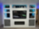 A mounted TV, modern shelves, blue LED lighting, and storage cabinets below