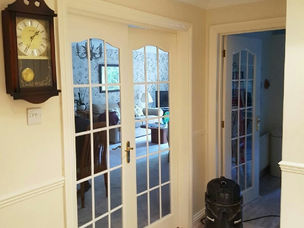 White French doors fitted beside a grandfather clock