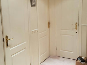 Cream panelled doors fitted along a hallway