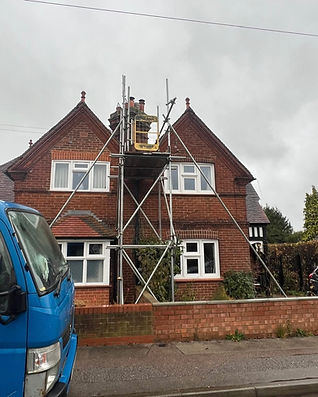 A red brick house with scaffolding