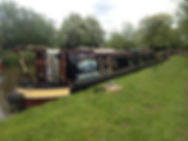 A boat named Chrissie parked near the bank of the river