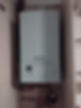 A white Vaillant boiler installed in a closet, with copper pipes connected below