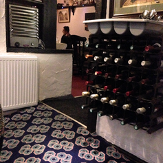 An interior featuring a wine rack with various bottles