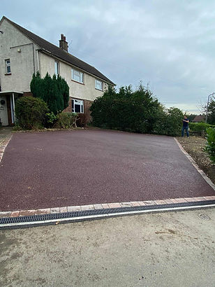 A freshly paved driveway in front of a house