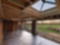 A partially constructed room with exposed beams and a skylight