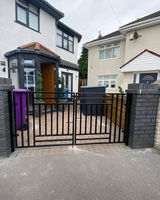 Exterior view of a house with a closed black metal gate