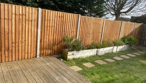 A small garden with wooden fencing