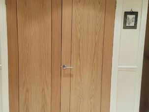 Pair of oak panelled doors fitted in a hallway