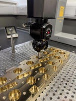 Gold metallic part under inspection for precision