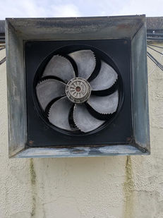 Front view of a professionally cleaning exhaust fan.