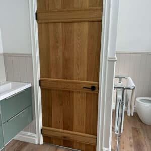Wooden bathroom door with black handler