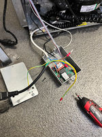 An electrical box with wires and a cord