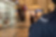 A security officer in a dark uniform stands in a mall