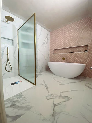 Modern bathroom with marble flooring and pink herringbone tiles