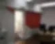 An office interior with painted walls and a desk with various office equipment