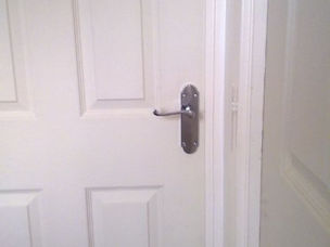 White internal door fitted with chrome lever handle