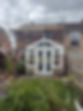 scaffolding and platforms above a conservatory at the back of a home