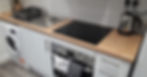 Modern kitchen setup with a wooden countertop