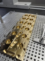 Metallic part resting on perforated silver base