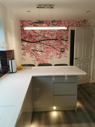 A kitchen with a cherry blossom wallpaper