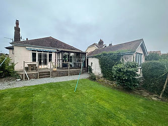 A house with a lawn and a fence