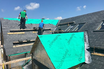 Professionals repairing the rooftop of a house