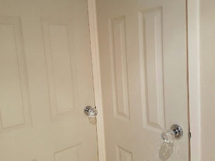 Glass door knob fitted on a white internal door