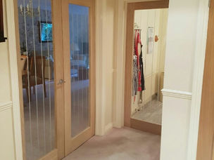 Glazed oak door fitted in hallway with mirror panel