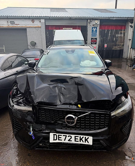 Black Volvo car with severe front end collision damage
