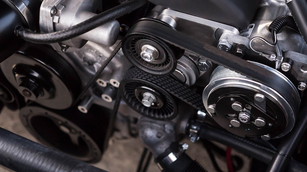 Close-up of an engine compartment showing a belt wrapped around pulleys