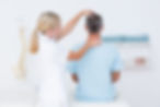 An orthopaedic professional examining a man during a consultation