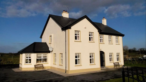 A cream-coloured house with an extension
