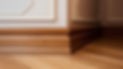 Elegant wooden baseboards in a corner, showcasing intricate moulding
