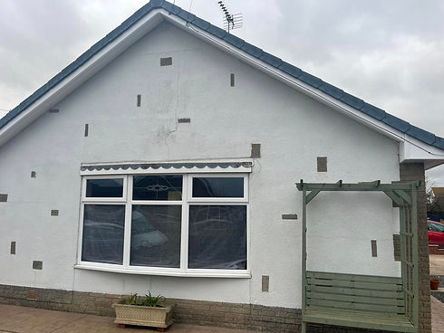 Bungalow front elevation undergoing wall preparation before external rendering application