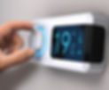 Close-up of a smart thermostat being adjusted to control home heating temperature