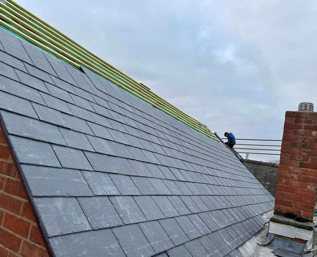 A partially constructed slate roof of a house
