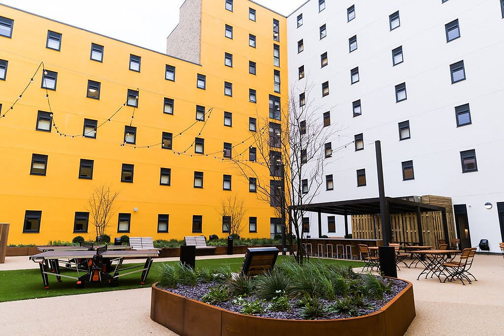 Urban courtyard with vibrant yellow and white building facades
