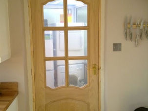 Glazed panel door fitted in a hallway doorway