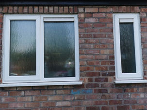 Before view of exterior of a window with water patches on it