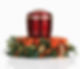 A red cremation urn surrounded by a vibrant wreath of orange roses