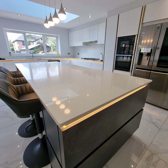 Modern kitchen island with LED under-counter strip lighting and pendant lights