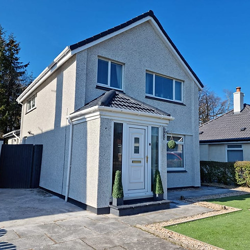 House exterior featuring pebble-dash walls and a textured finish
