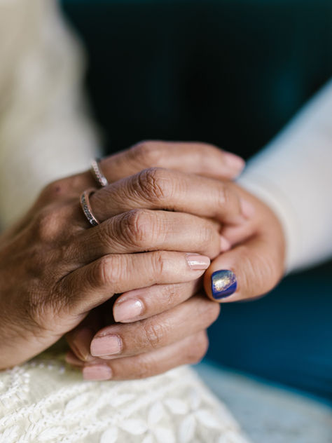 a hand comforting another.