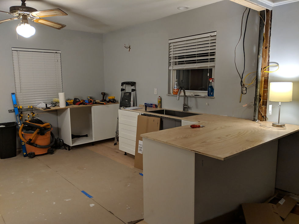 Kitchen renovation in progress with new cabinets and countertop templating.