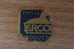 Worn blue vintage label reading “This is an Ercol product” fixed inside a wooden cabinet