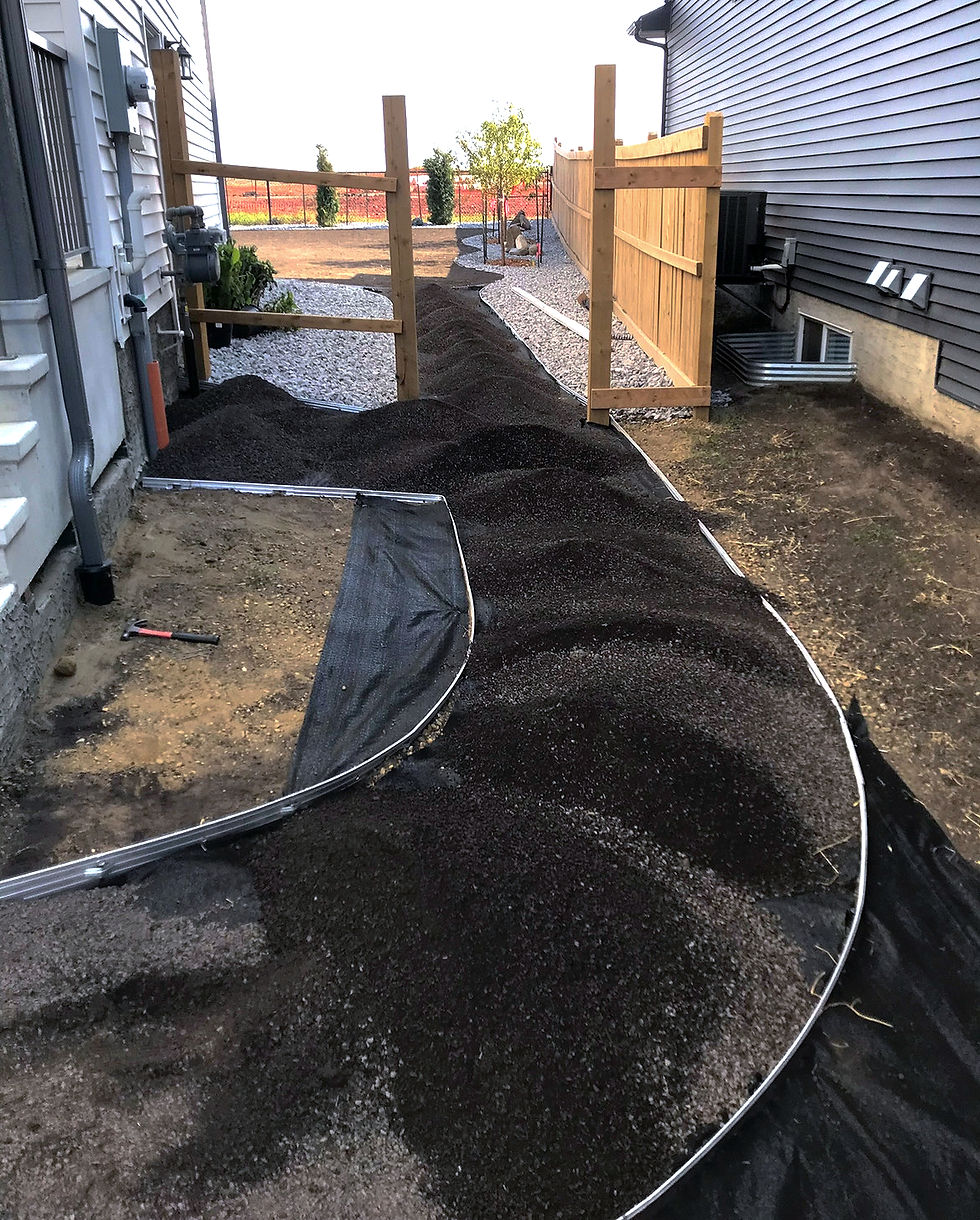 Lawn grading and topsoil preparation before landscape install in Leduc.